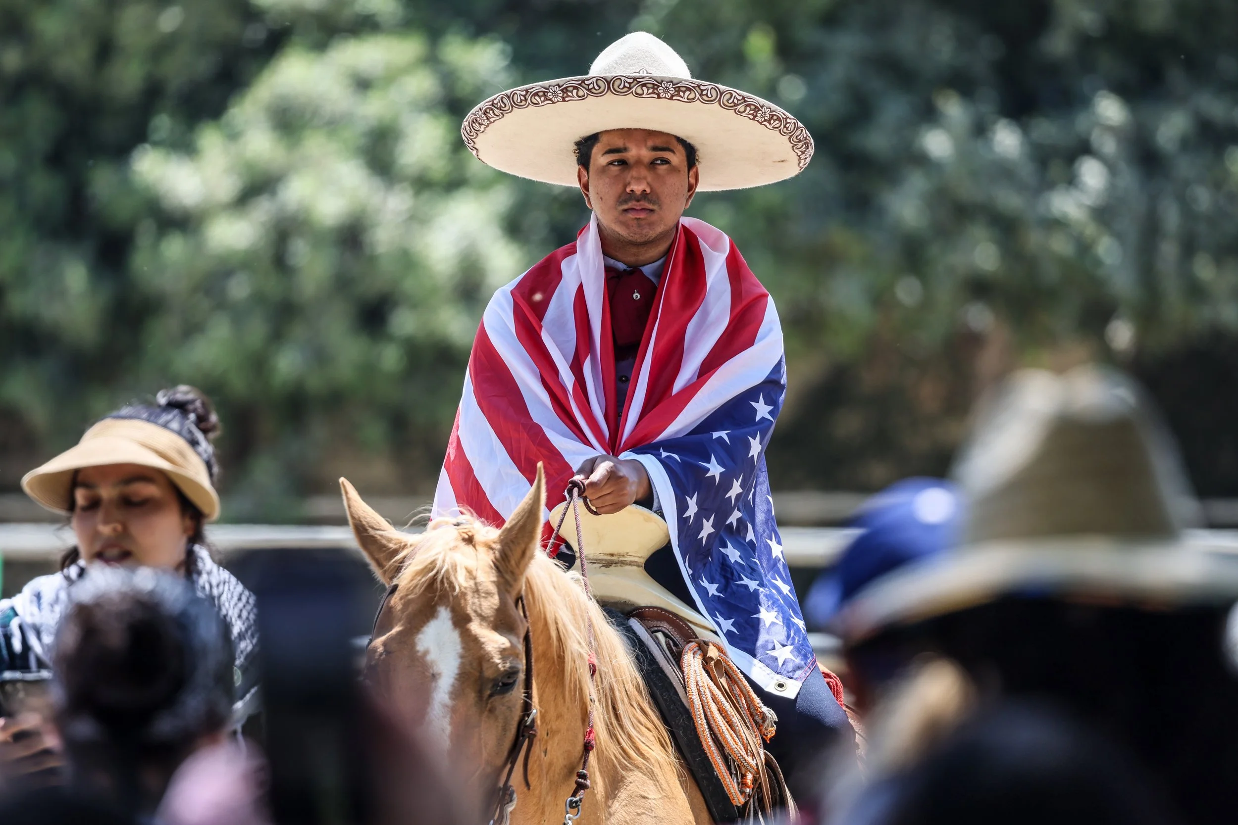  La Puente, CA, Sunday, June 15, 2025 - Vaquero Robert Cervantes looks on as demonstrators prepare to march from Avocado Heights to La Puente city hall in support of immigrant’s rights. 