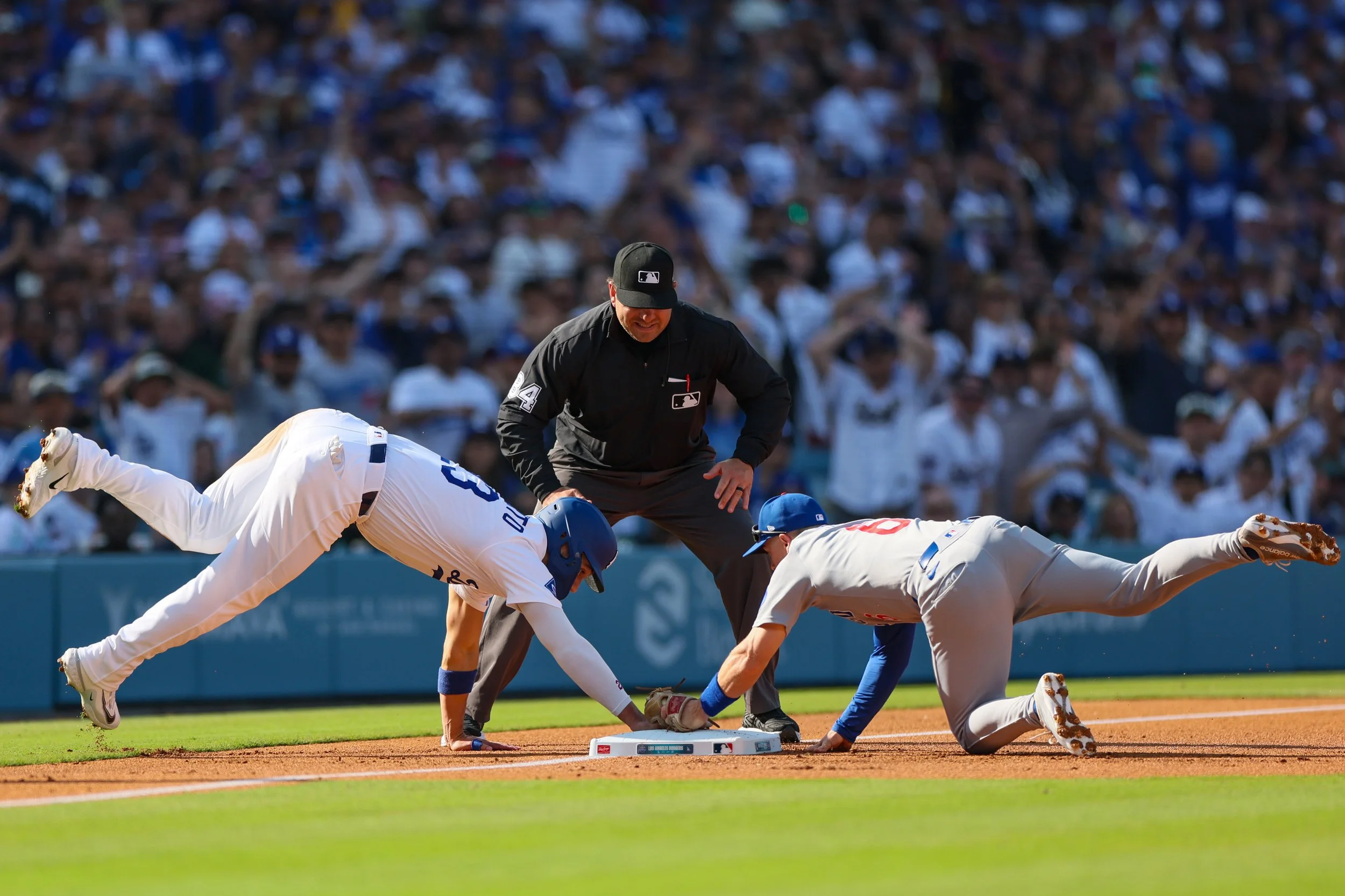  Los Angeles, CA, Sunday, April 13, 2025 - Los Angeles Dodgers outfielder Michael Conforto (23) is safe at third as he slides by the tag of Chicago Cubs Chicago Cubs third baseman Matt Shaw (6) during a second inning rally at Dodger Stadium.  