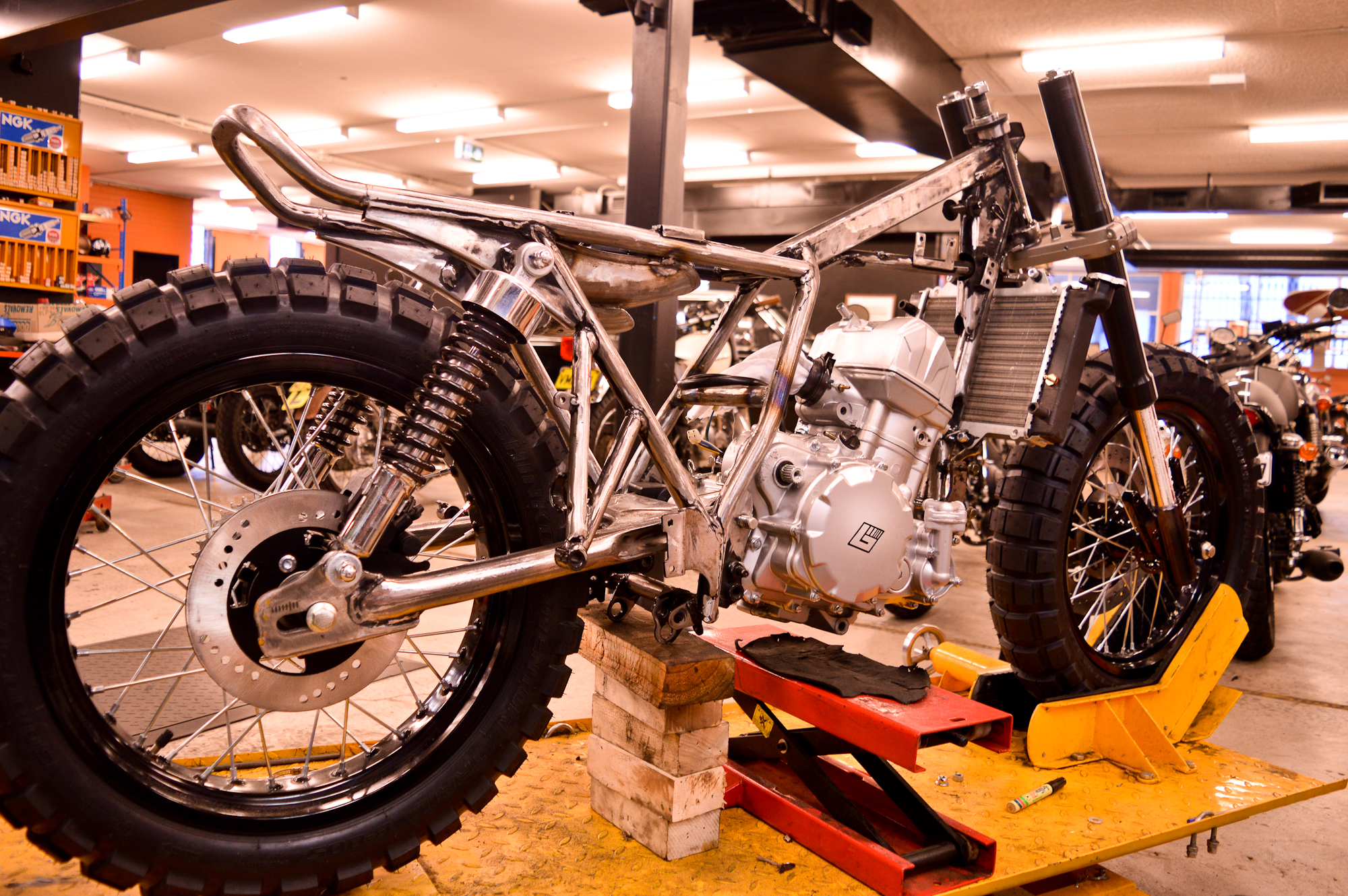 Progress on the Braaap build for the 2015 Throttle Roll. Big thick knobbly tyres have gone on and frame modified to hold the 450cc engine. The beast emerges. 