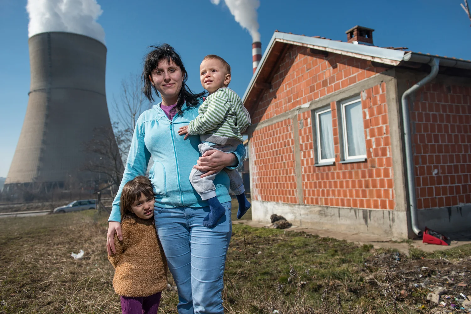 Meheteme B. (25) and hr children Ermonda (4) Ermond (2) standing in their garden