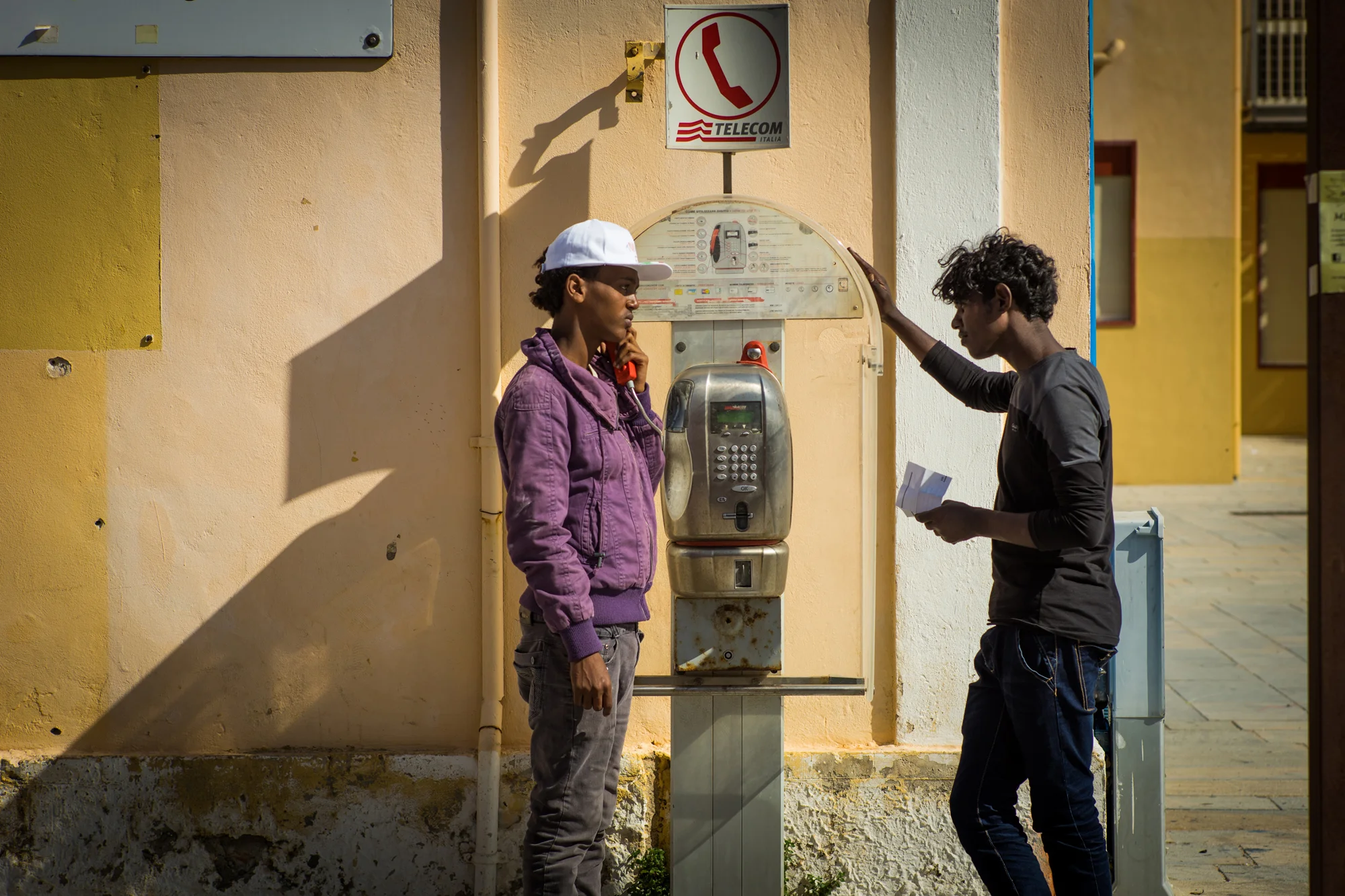 eritrean refugees try to inform their families that they survived the trey houris journey from their war torn home, to the European Union.