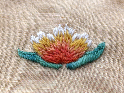 A piece of crewel wool embroidery in process.