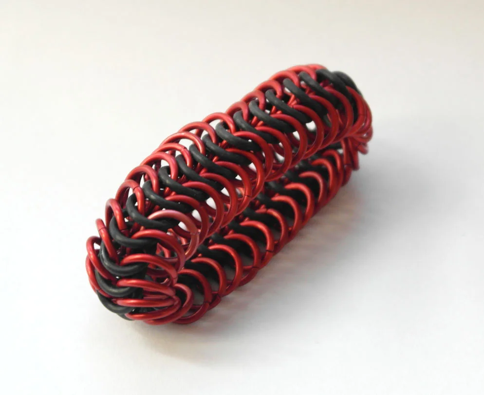 A stretchy neoprene and anodized aluminum bracelet in European 6 in 1