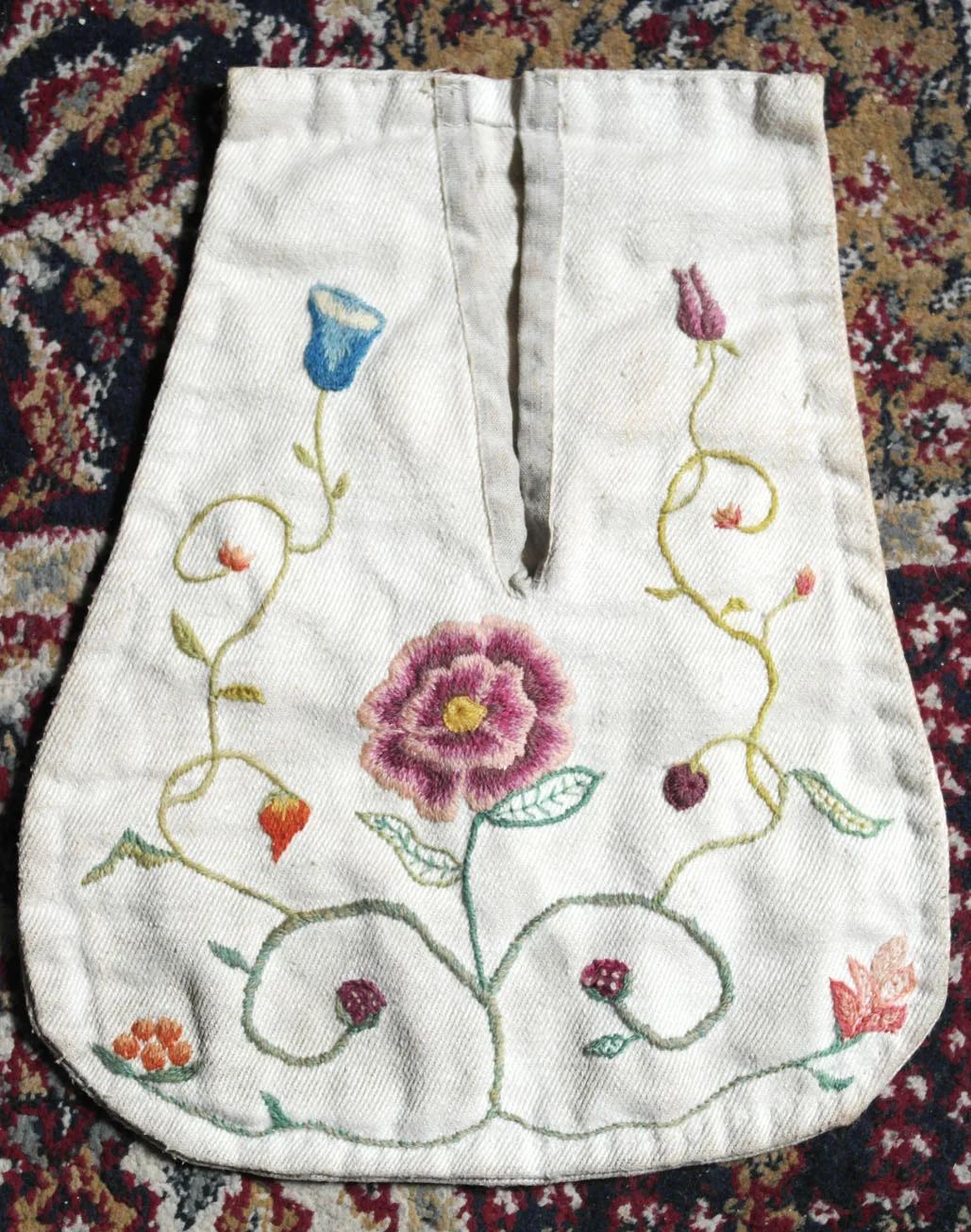An shot of a reproduction 18th century embroidered pocket, by Aurora Simmons. Crewel wool on linen.