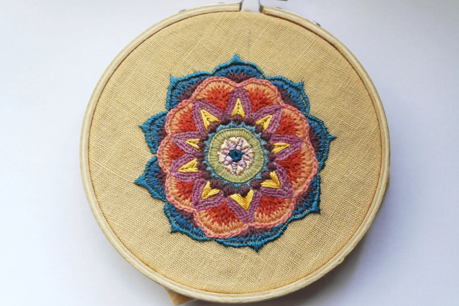 Embroidered mandala by Aurora Simmons with silk and crewel wool.