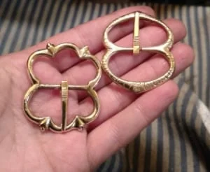 A pair of medieval reproduction buckles which are soon to be plated gold and silver respectively. Brass.