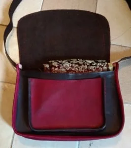 Leather purse, completely hand dyed, tooled and stitched. You can see the fabric I will be lining with peaking out. The dark pink will be more burgundy by the time I am finished.