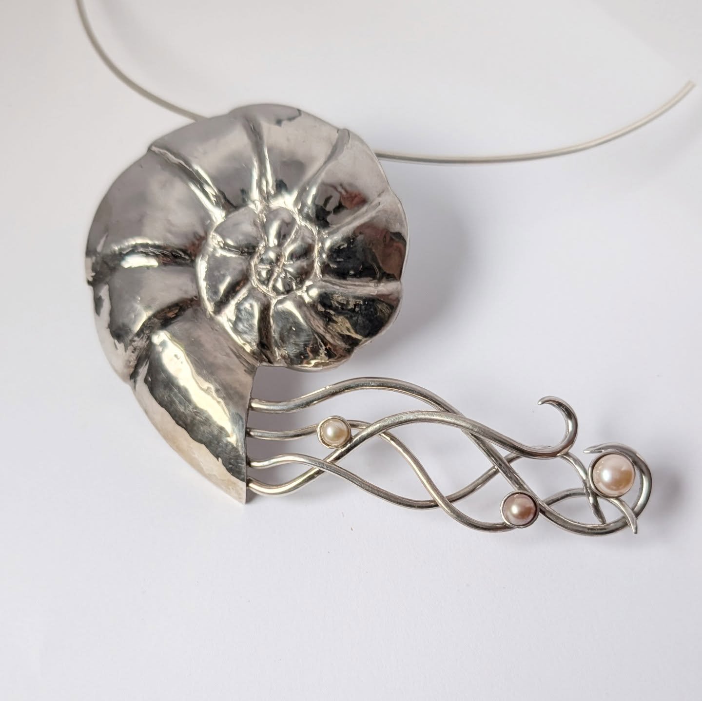 I will have a long process video coming soon but I am just so delighted with this repousse neckpiece I finished up recently. This was a bigger piece. All sterling silver set with pearls and it floats on the neck as if defying gravity. It was a very l