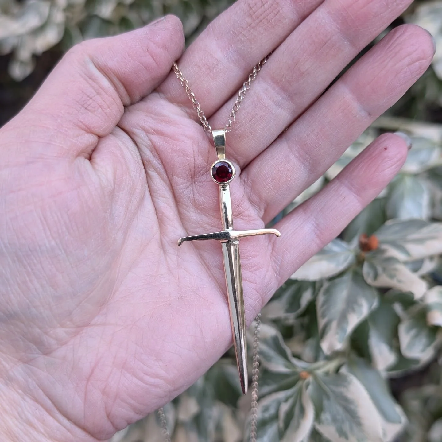 Loving that pop of colour with the faceted garnet longsword pendant. This is available as a necklace or a brooch. I've been thinking about doing a smaller version without a gem.  What do you think would you wear it? #longsword #pendant #hema #mensjew