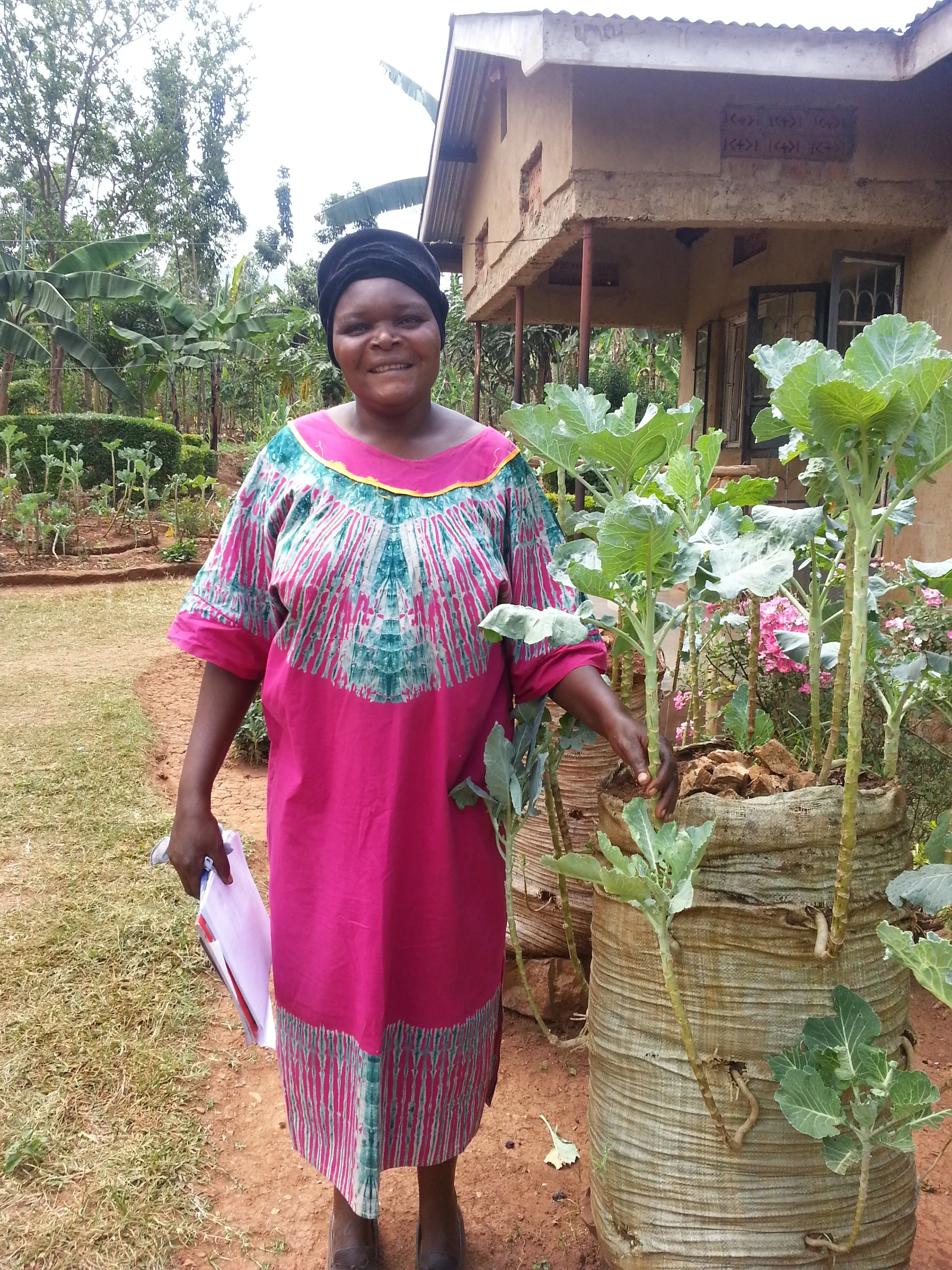 Pictured: Marguerite in Kenya with her water saving bag garden. Image credit: Send a Cow