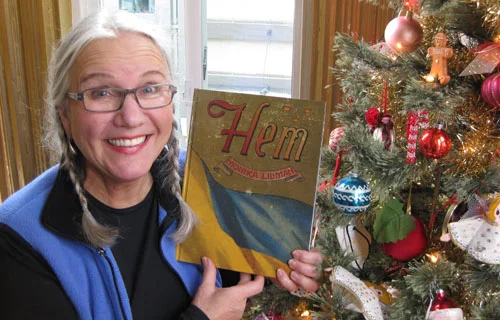 Monika holds the first copy of her book Hem .