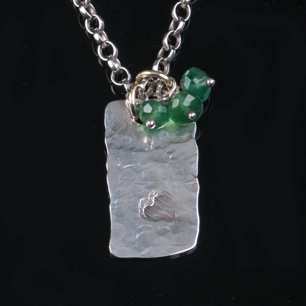 Solid silver tag with emerald reverse.jpg