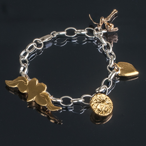 Charm bracelet with gold and silver charms