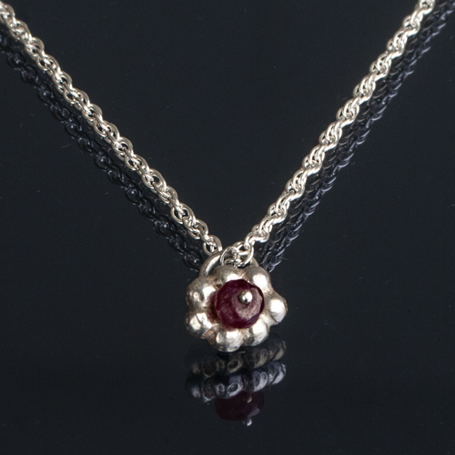 Silver pendant with ruby setting
