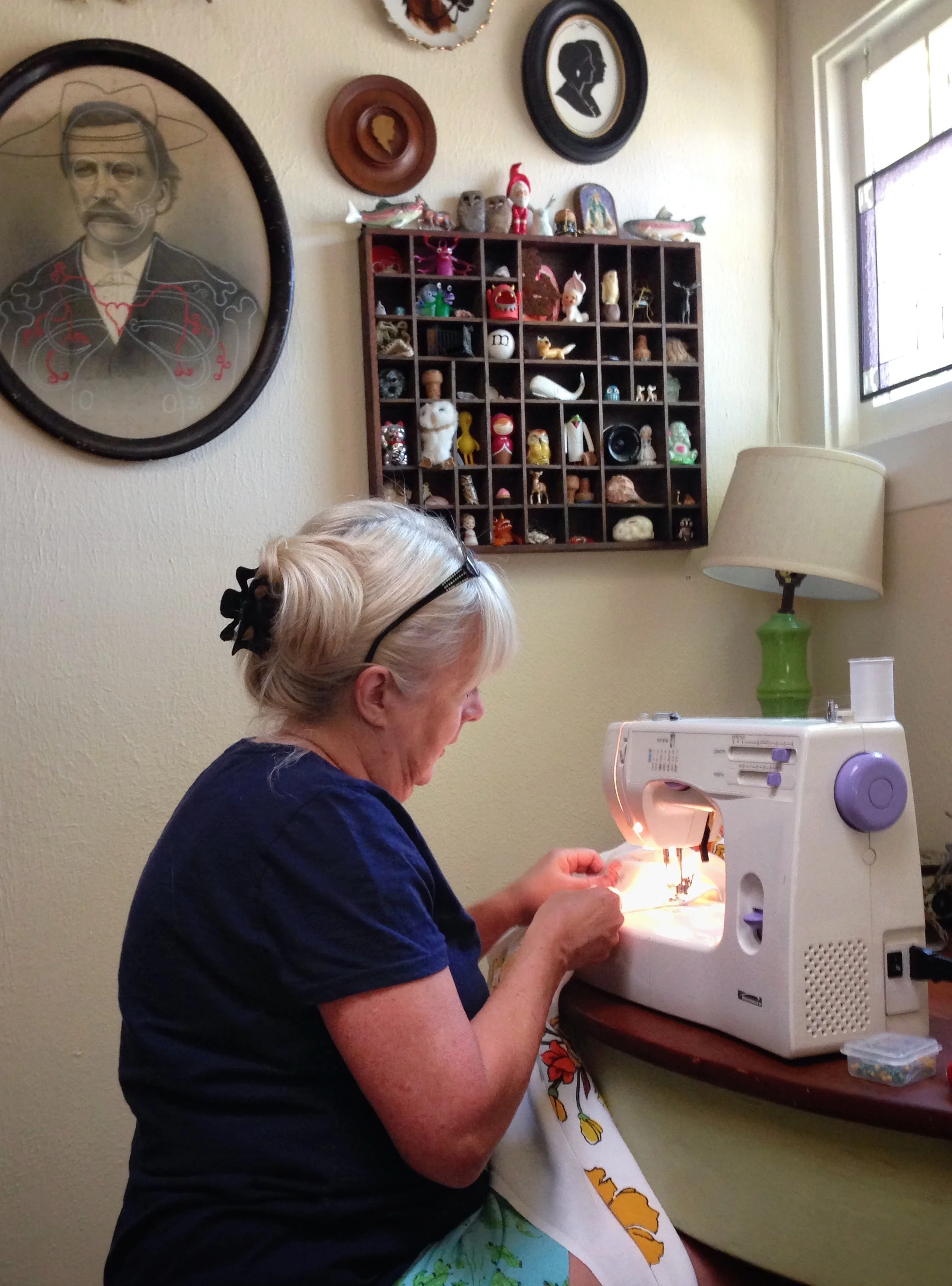 Mimi, skillfully stitching up our vintage tablecloth.