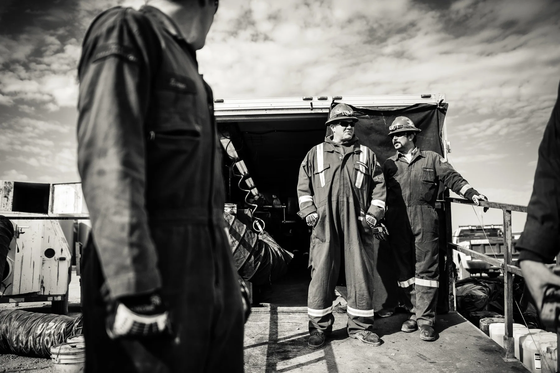 A wireline crew waiting for operations to commence. The wireline operators are responsible for inserting and setting off the shaped explosive charges that penetrate the drill pipe and surrounding rock thus allowing the high pressure water to radiate into the surrounding rock and release the oil.