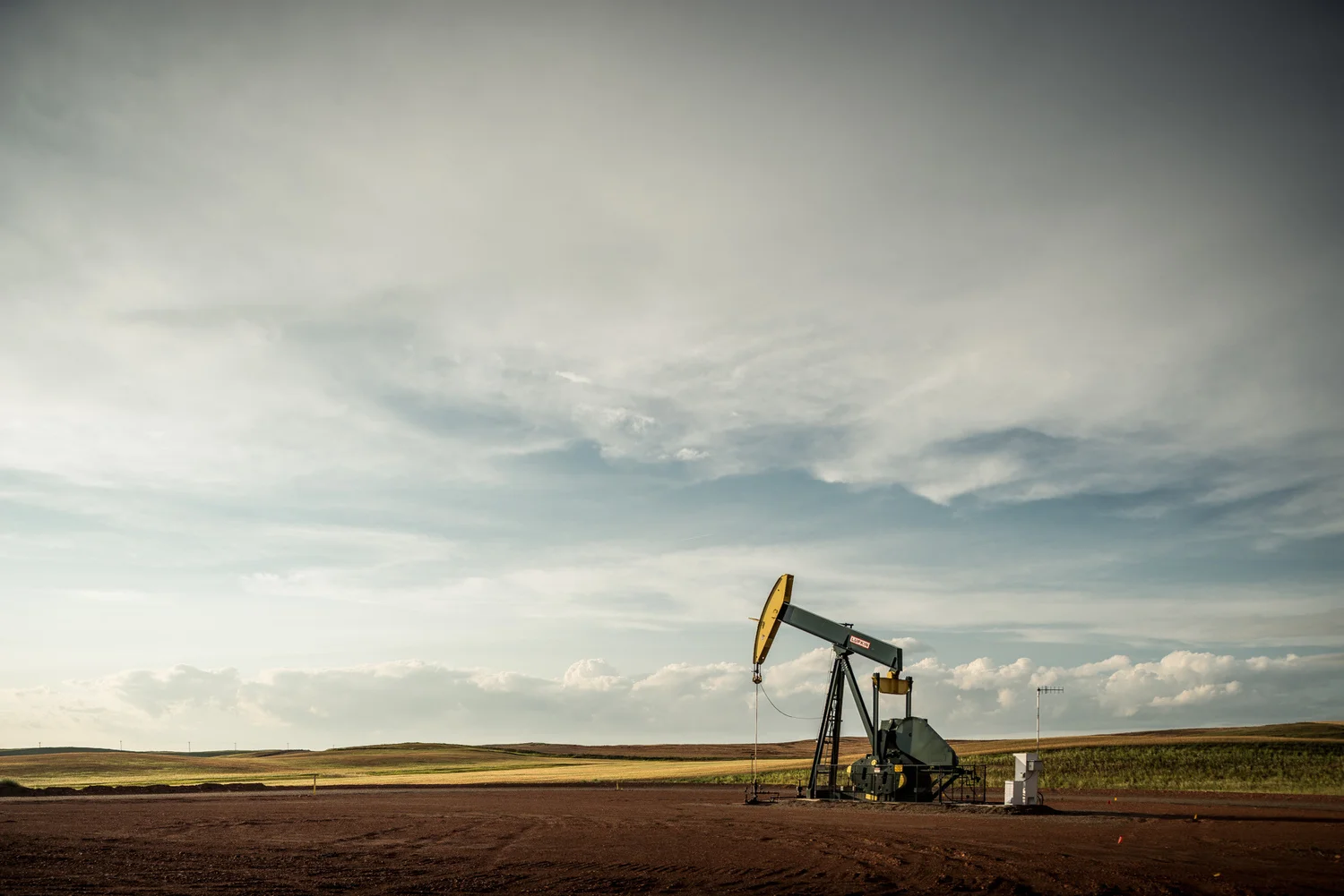 A Hess oil pump jack overlooks the North Dakota oil fields known as the Bakken in the aftermath of a thunderstorm.