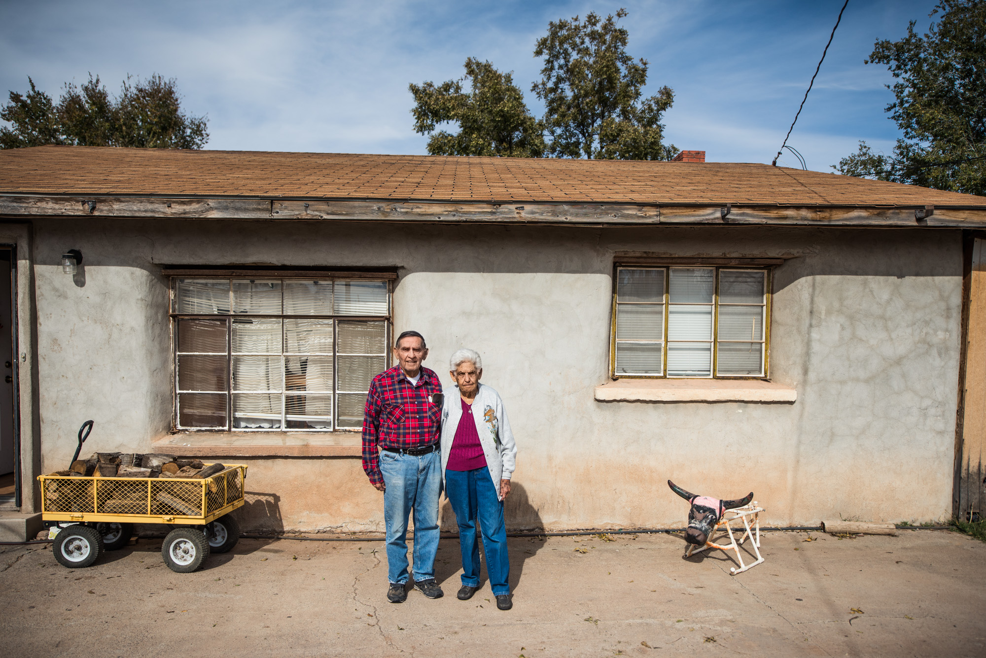  Fructoso Marujo, a distant cousin,&nbsp;and his wife outside the adobe home in Tularosa that he built back in the 1950's. Currently their children and their grand children live with them in the upgraded and modern baked-clay residence. 