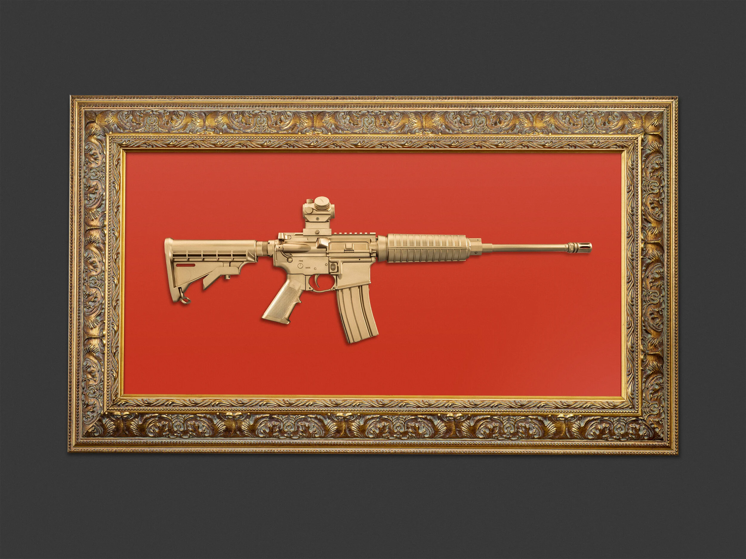 red background and gold gun in frame.jpg