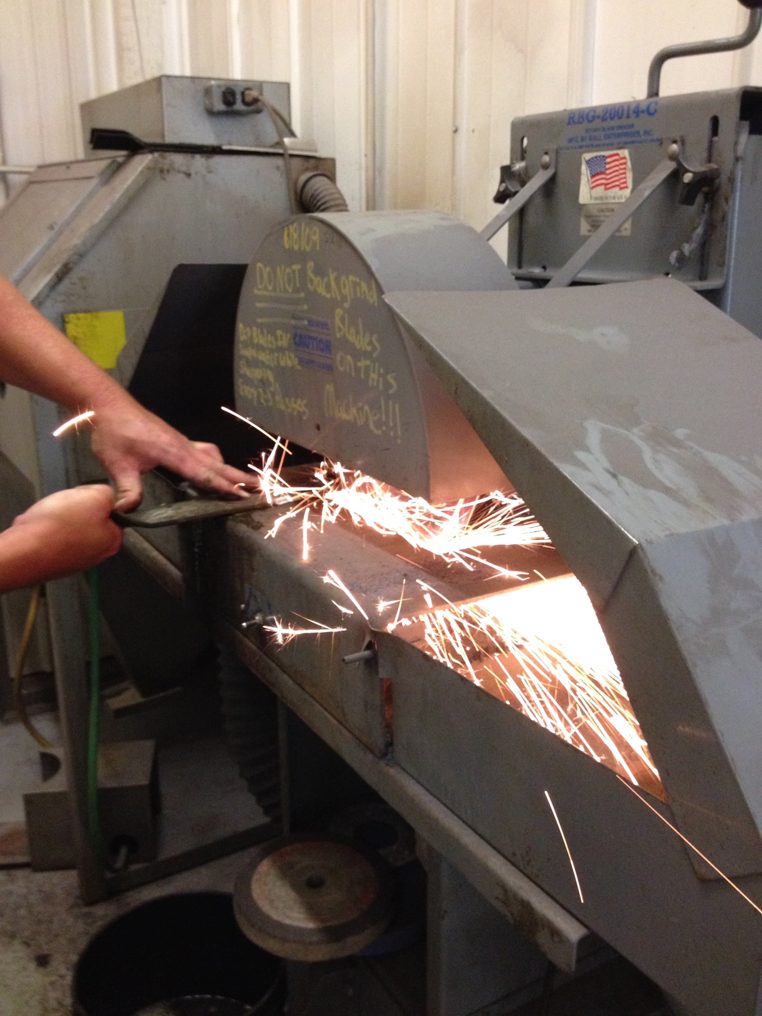 Run the blade against the grinder with the stone spinning downward