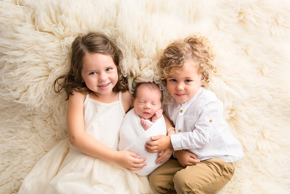 first hugs with a newborn brother and sister photo idea