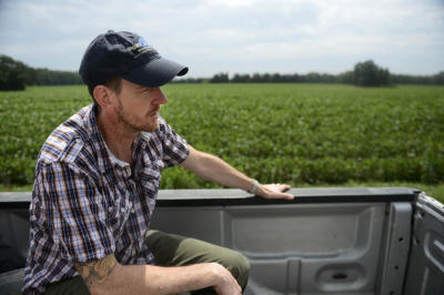 Tutoni's executive chef Scott Robinson rides in the back of a truck to see the pigs he buys for the restaurant at Rettland Farm in Adams County. Even when working at other restaurants, Robinson brought Ramsburg's meat along for the ride, and it's now served in Baltimore restaurants thanks to their connections.