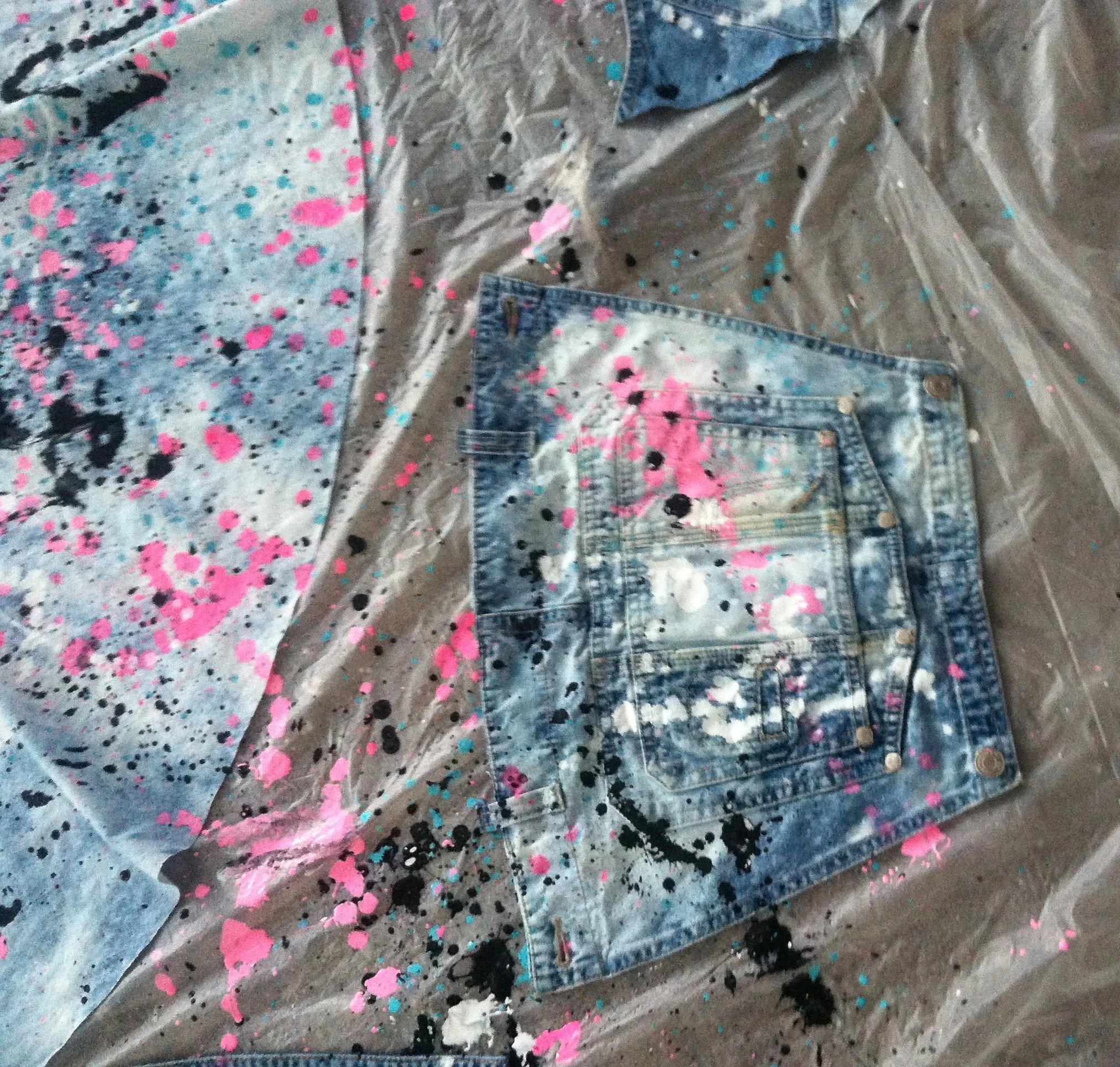 So. much. fun. Thrifted overalls and a chunk of chambray denim that was close in color for the skirt. I have always loved wearing overalls shorts in the summer, and I thought it would be fun to explore the idea of work clothes we wear while doing painting projects, etc. Back in some of my art classes we would use our large gray paper table covers that were covered in paint from various projects, and cut them into strips to create beautiful weavings. I love the idea of using splattered drop cloths for projects too. I dripped bleach on both to unite the color a bit more, to make them look like they were the same fabric. Then went to splatter town with paint. What a blast. 3 different people said the final dress looks like something Katy Perry would wear. Fun! I'll post the final look after Aug. 18!!