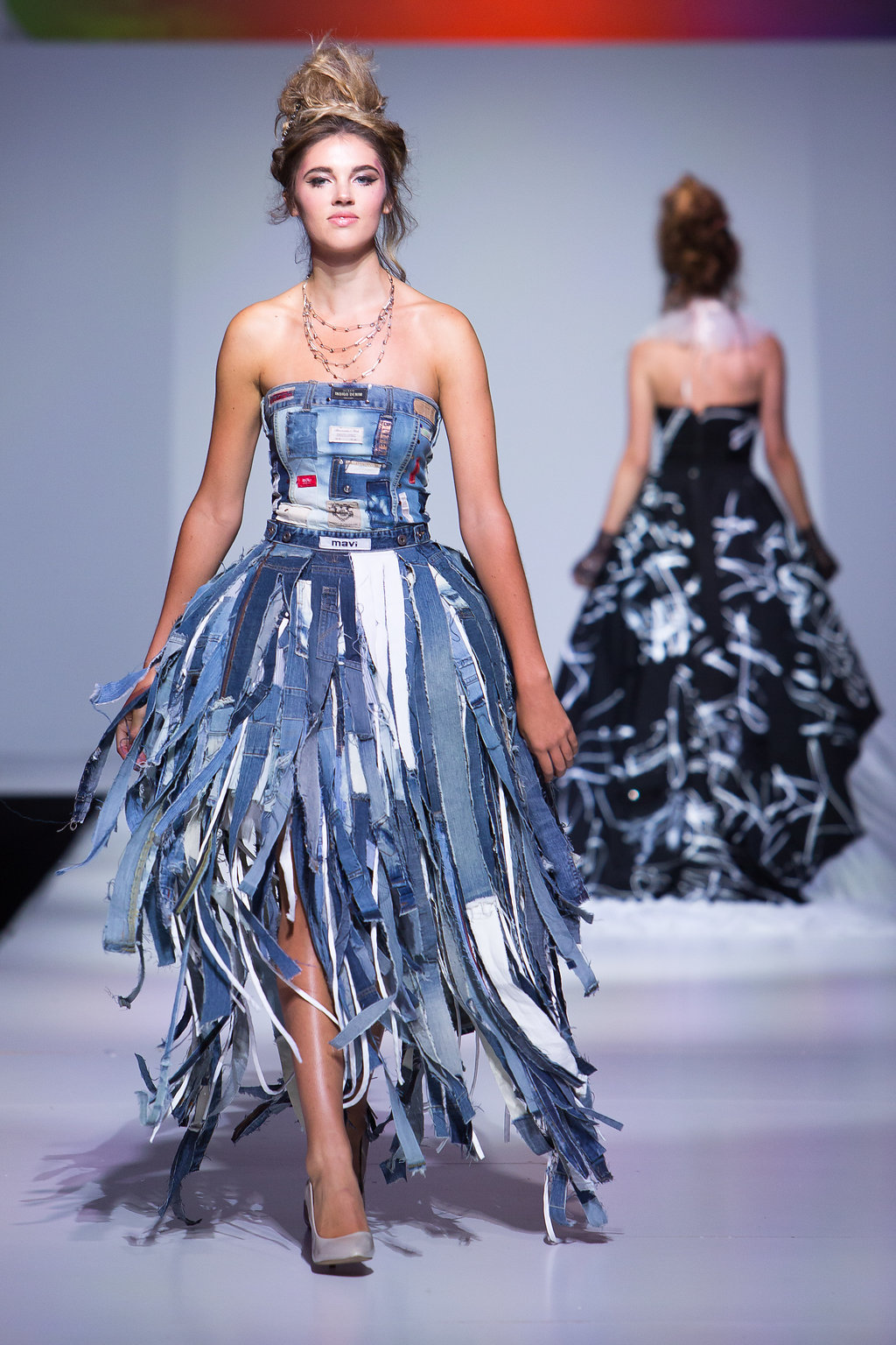 Deconstructed denim jacket, with recycled jeans sewn into strips. Pannier underneath