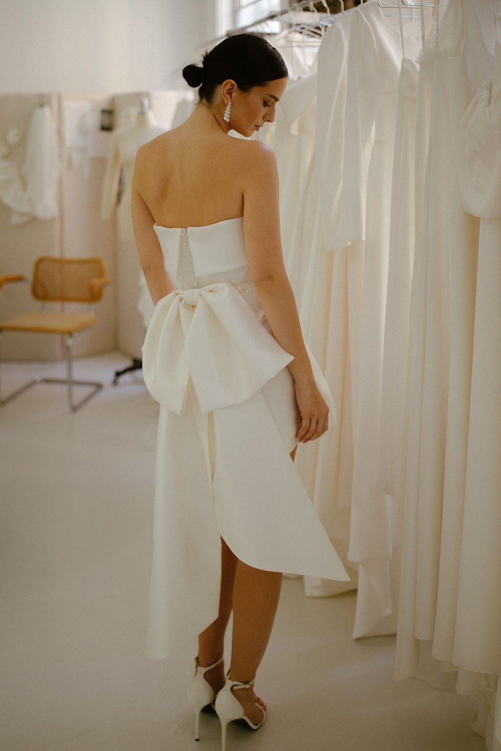 The Alexa Mini is a structured Mikado mini dress that blends timeless tailoring with playful modernity. Featuring a supportive boned internal bodice, a clean bias band neckline and a softly flared A-line mini skirt, Alexa offers a contemporary interp