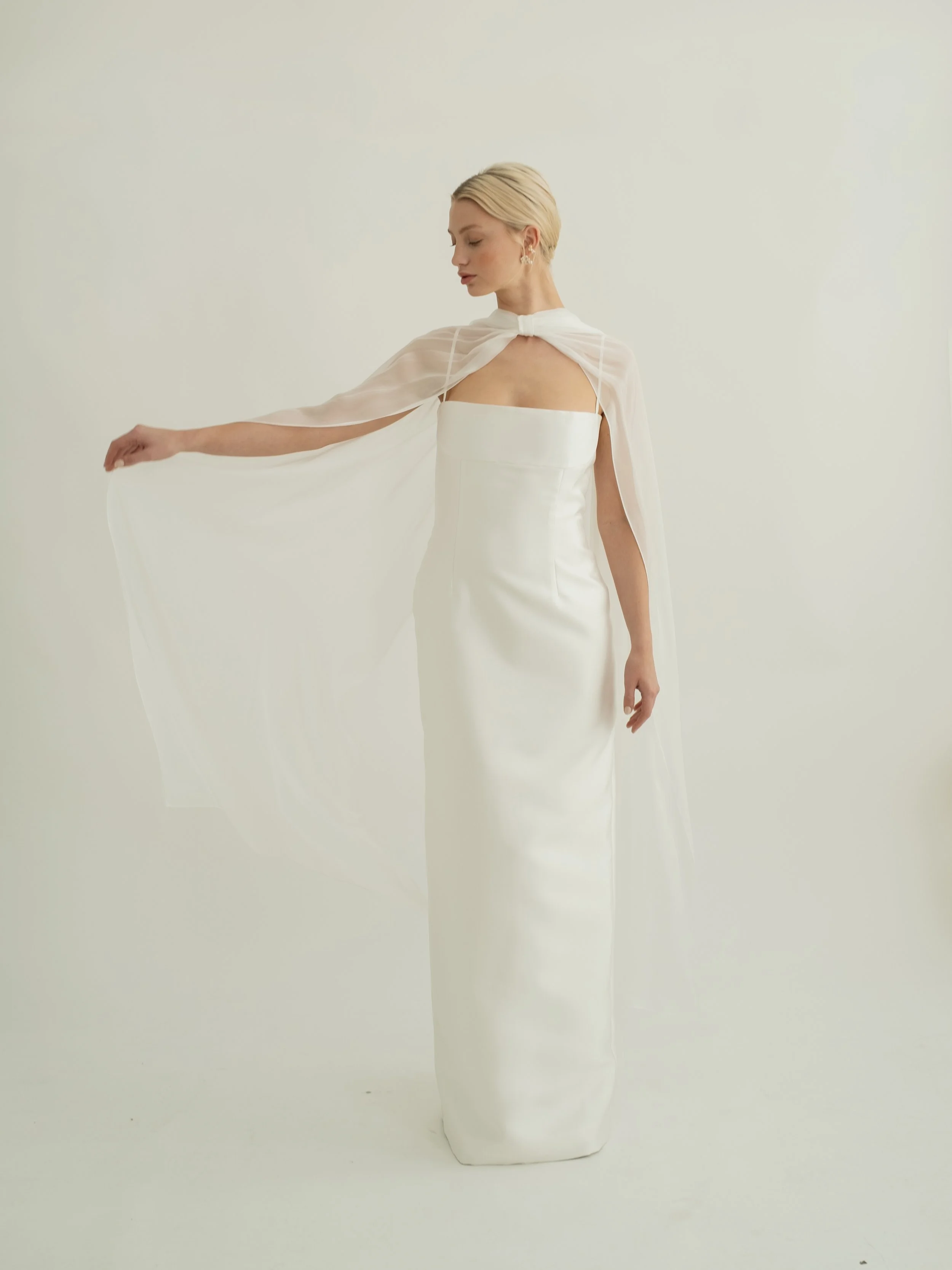 An elevated neck scarf made in silk chiffon with tiny rolled hems, the Sian scarf features pleated gathers at the neck with soft bow detailing. For an effortlessly cool look, this piece is designed to be worn on the shoulders rather down the back giv