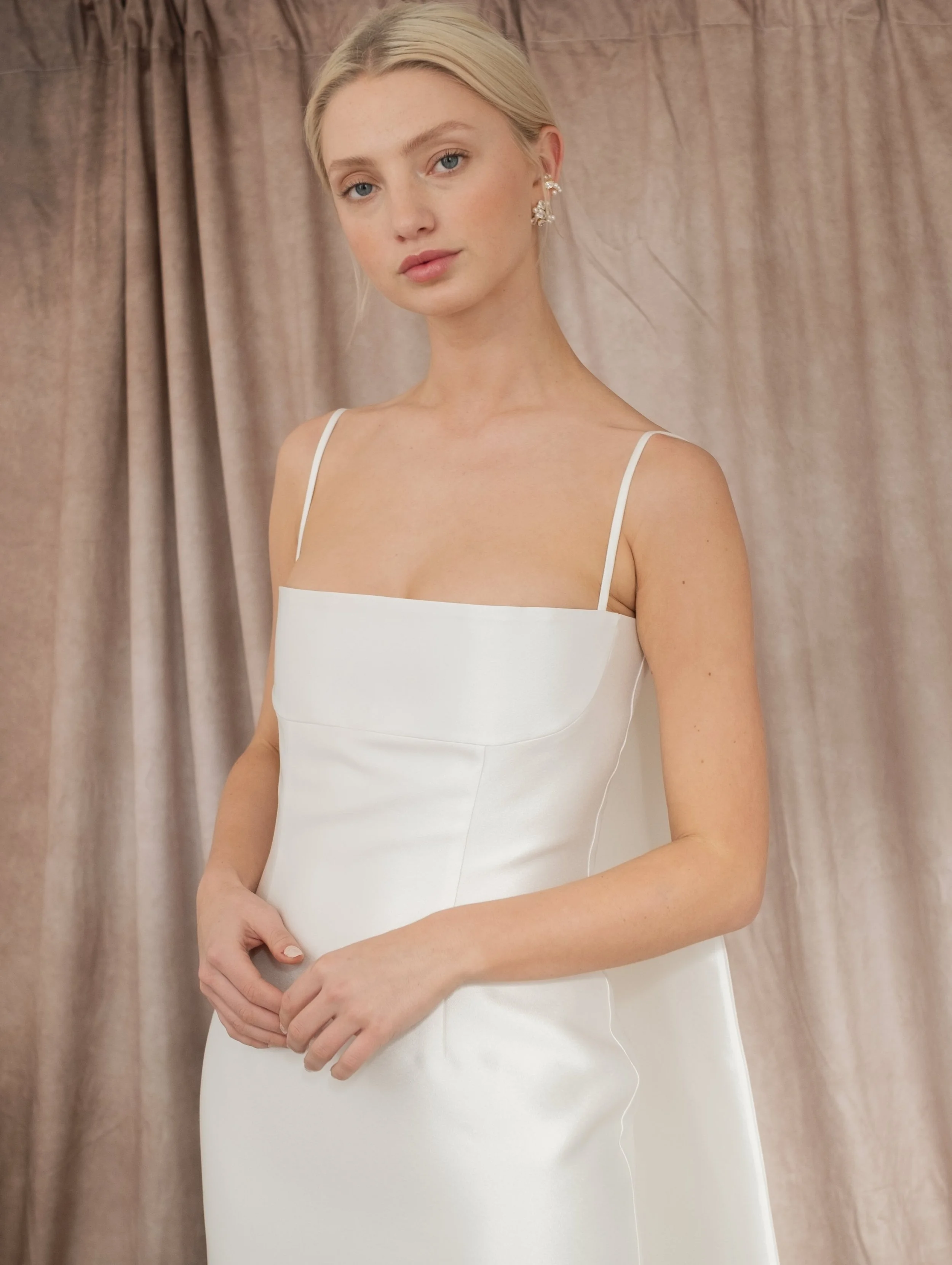 When wedding dress by Jessica Bennett a minimalistic gown which features
a darted waist and column skirt silhouette with removable train 