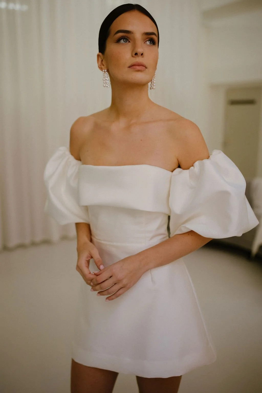The Alexa Mini is a structured Mikado mini dress that blends timeless tailoring with playful modernity. Featuring a supportive boned internal bodice, a clean bias band neckline and a softly flared A-line mini skirt, Alexa offers a contemporary interp