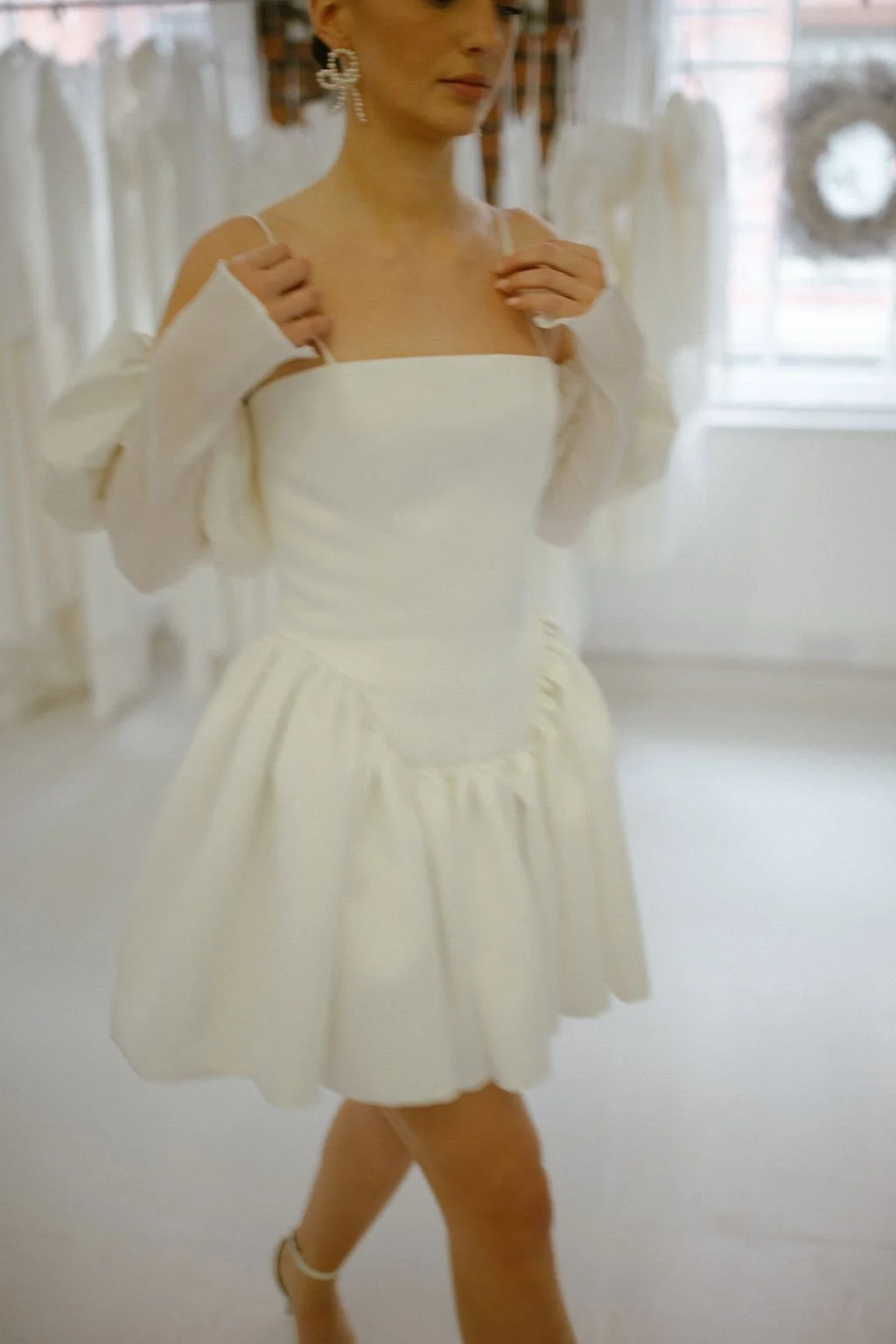 Where maximal gathers and volume meets minimal necklines and detailing. The Delphine Mini features an extended dropped waist bodice, cut to highlight the feminine form and mini gathered skirt. Constructed in buttery soft duchess satin, with the inter