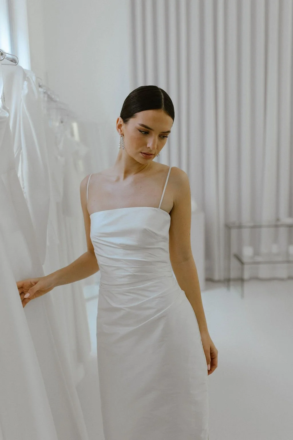 The perfect reception or civil ceremony piece. The She Midi features side waist pleating, an above ankle hemline and side split. Style alone or layer with our sleeve / bow additions for an interchangeable look. Fastens with concealed side zip allowin
