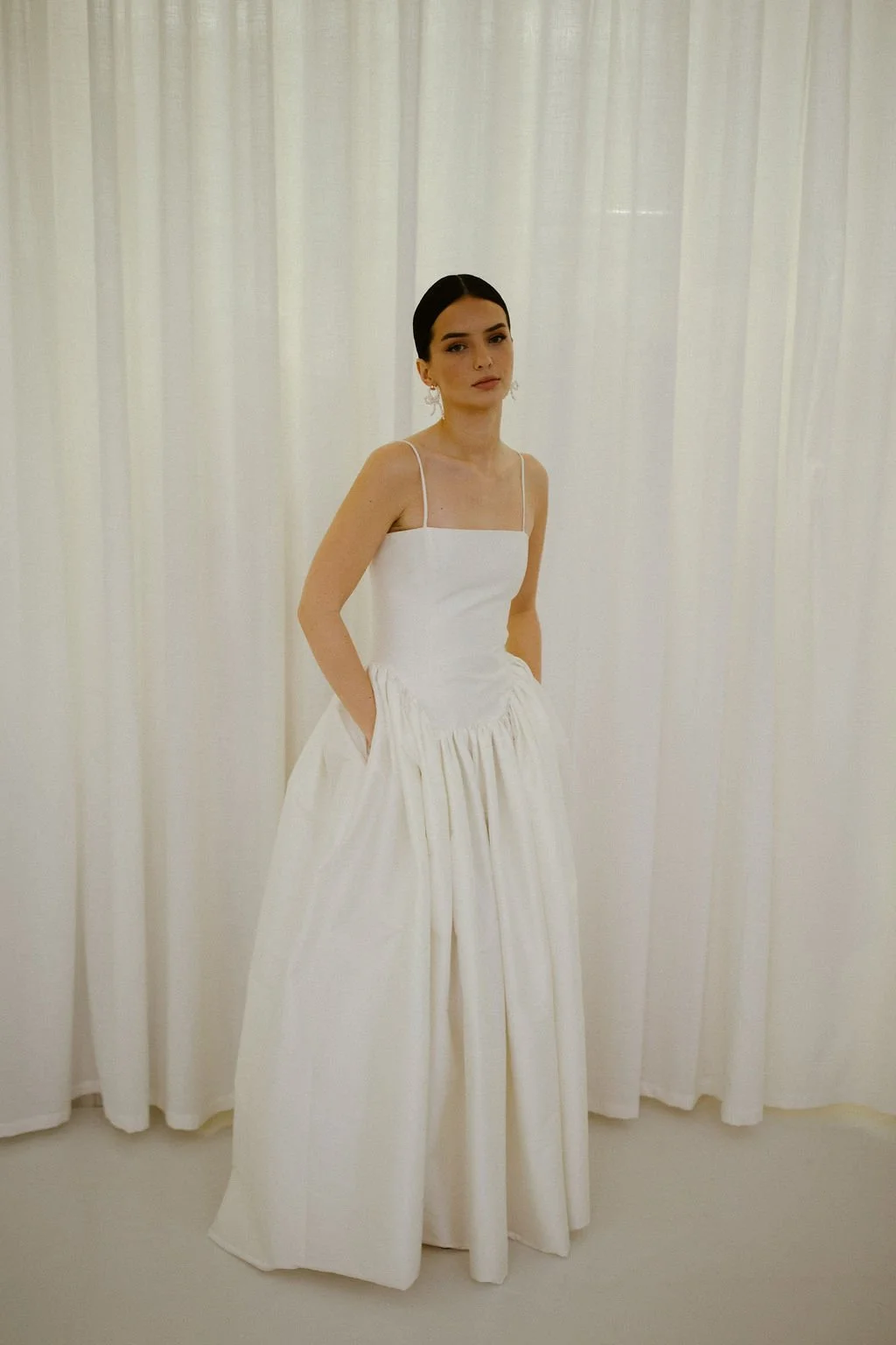 Delphine wedding dress by Jessica Bennett features an extended dropped waist bodice, cut to highlight the feminine form and full
gathered skirt 