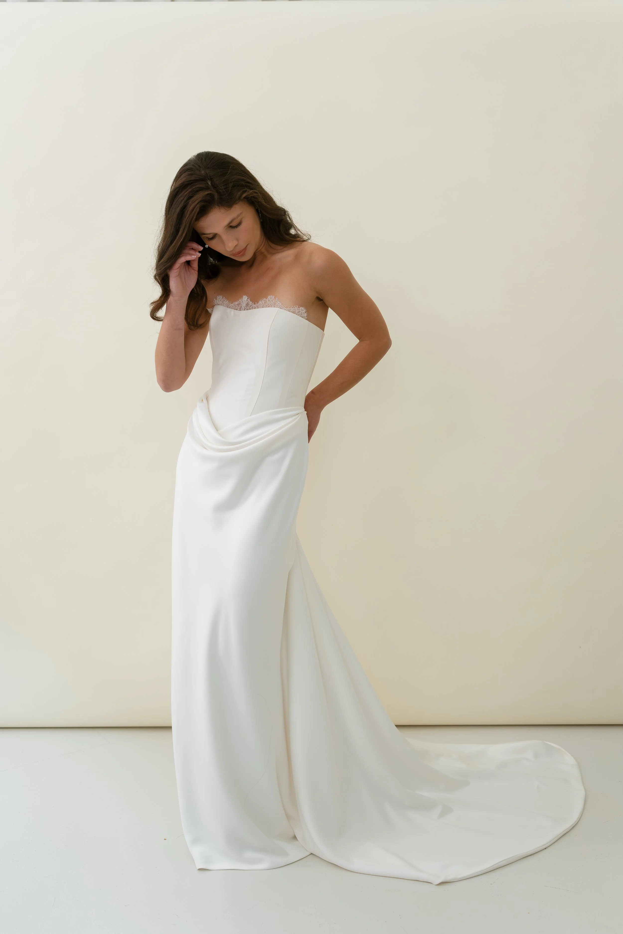 Tali dress by Jessica Bennett corset bodice with draped bias cut satin skirt and lace trim modern romantic bridal look