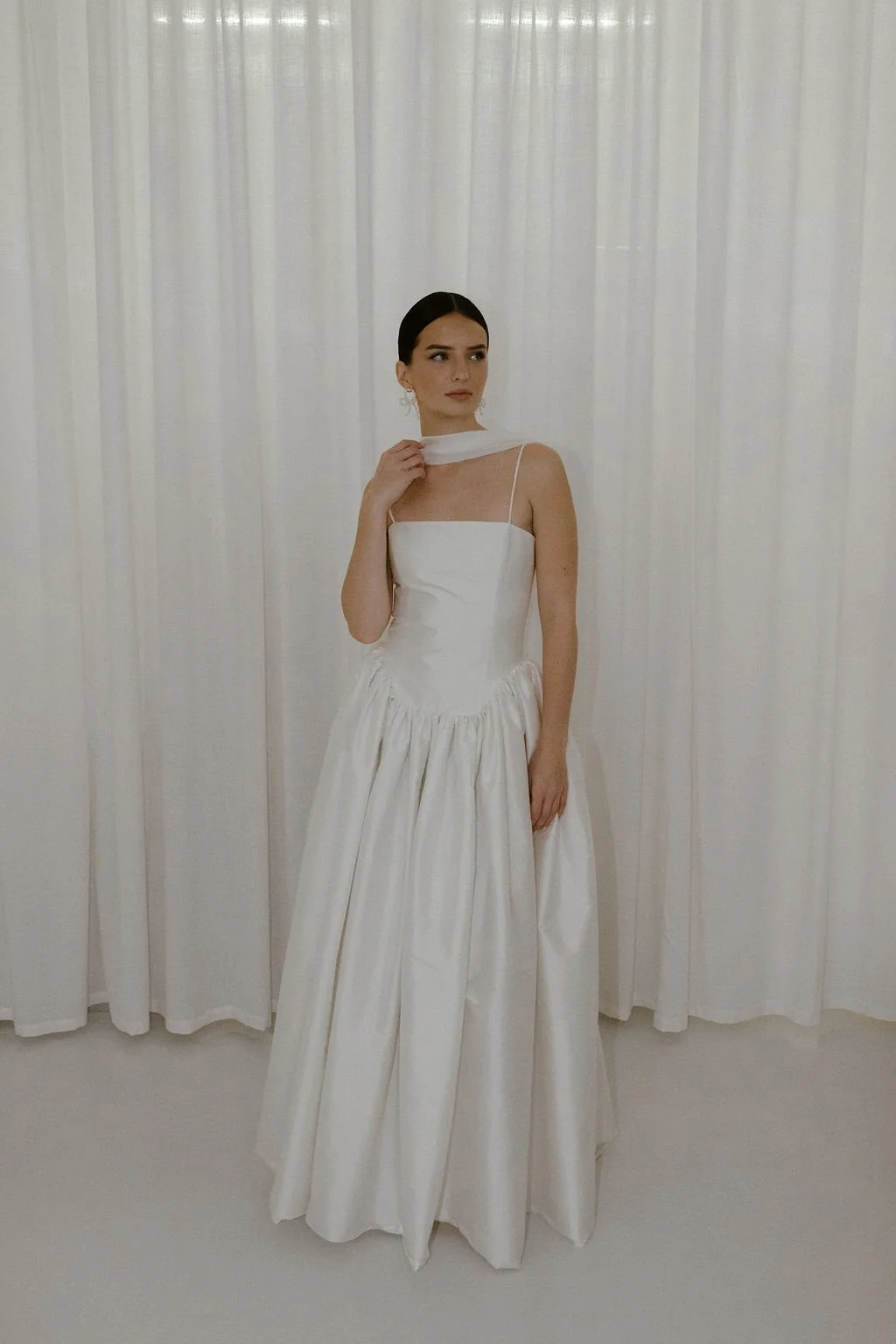 Delphine wedding dress by Jessica Bennett features an extended dropped waist bodice, cut to highlight the feminine form and full
gathered skirt 