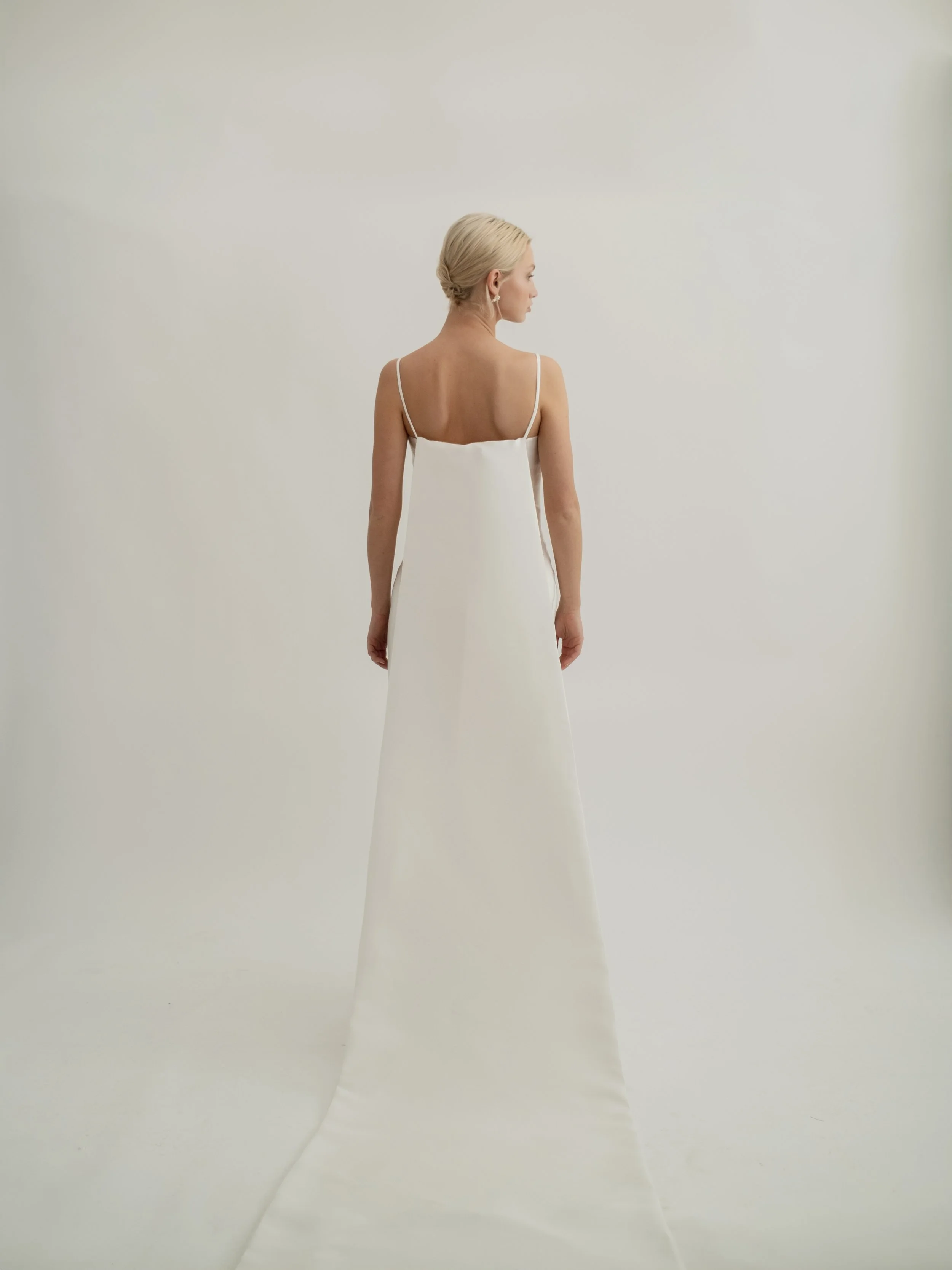 When wedding dress by Jessica Bennett a minimalistic gown which features
a darted waist and column skirt silhouette with removable train 