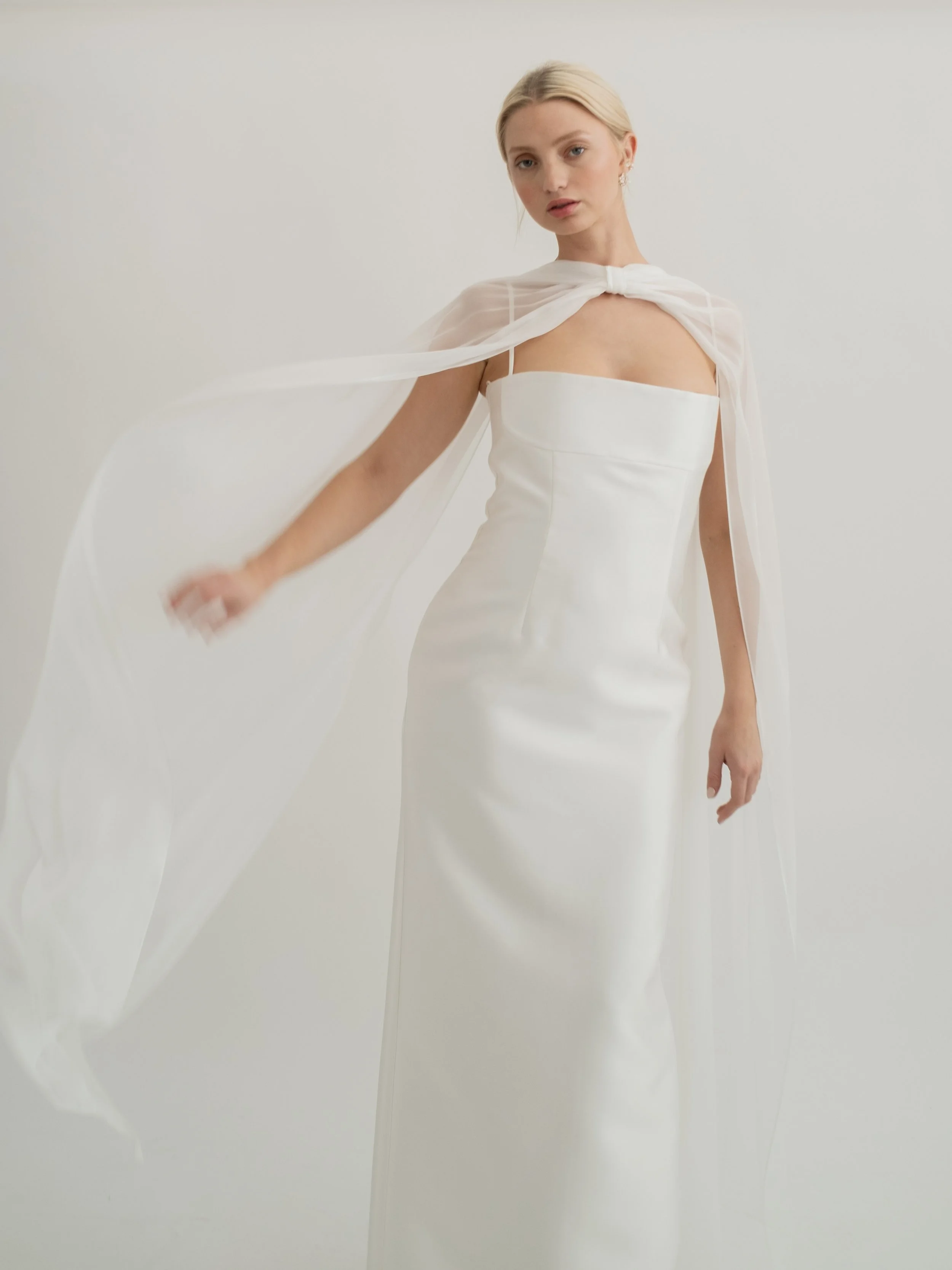 An elevated neck scarf made in silk chiffon with tiny rolled hems, the Sian scarf features pleated gathers at the neck with soft bow detailing. For an effortlessly cool look, this piece is designed to be worn on the shoulders rather down the back giv