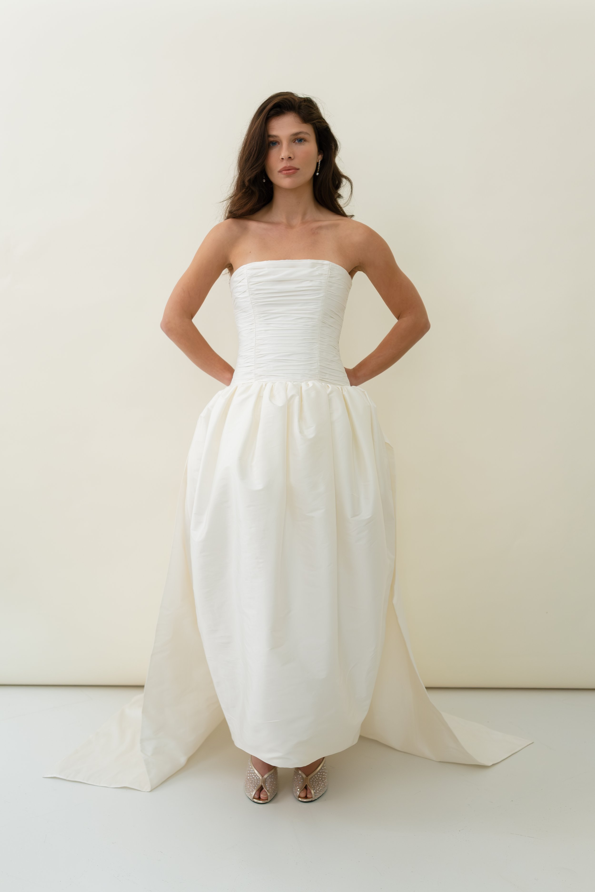 A chic removeable bridal separate, that allows for a dramatic optional train on  our Sloane dress and Cecile dress. Gathered taffeta and internal tulle give a voluminous train that fastens on to the back waist of gowns with hook and loop fastenings. 