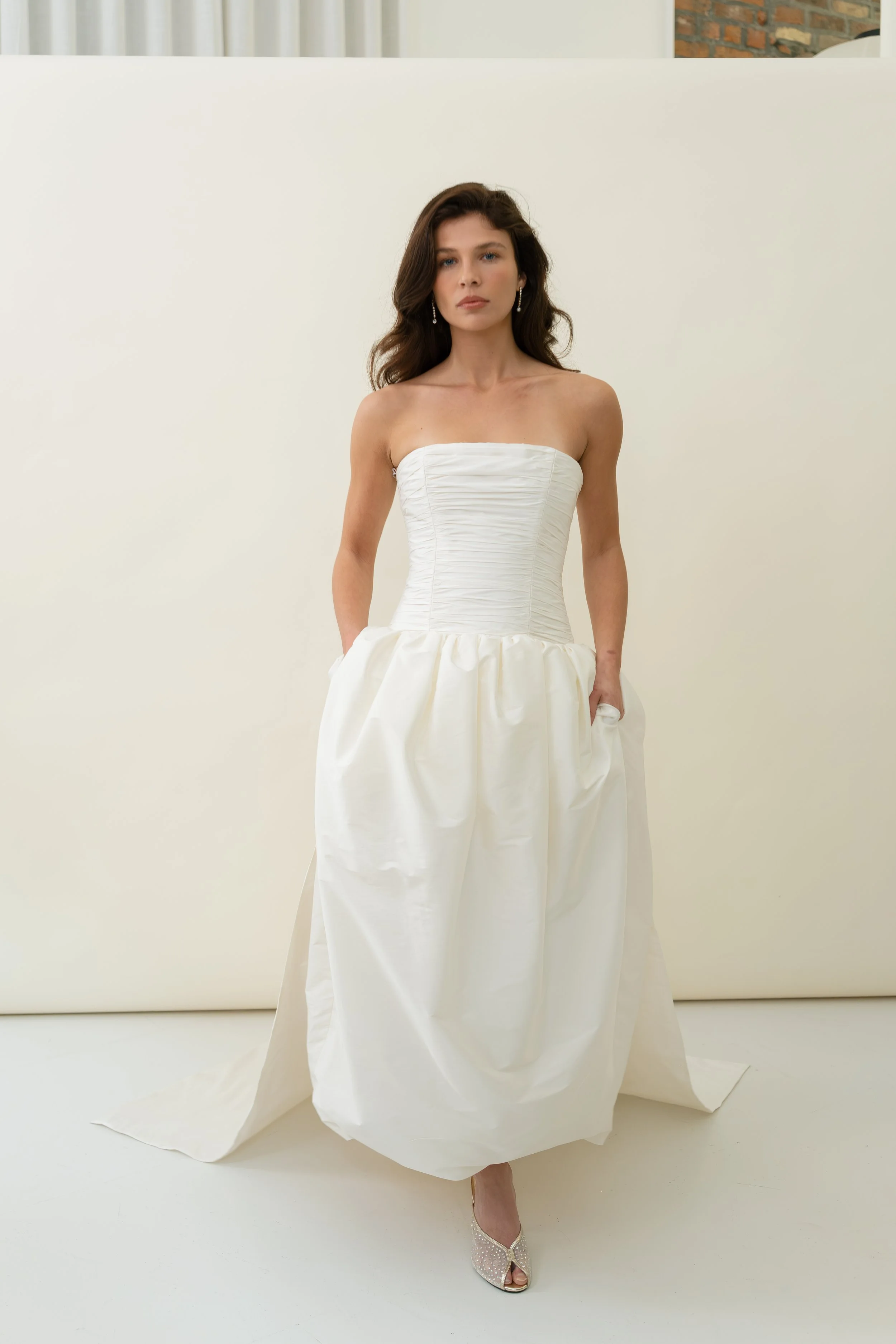 A chic removeable bridal separate, that allows for a dramatic optional train on  our Sloane dress and Cecile dress. Gathered taffeta and internal tulle give a voluminous train that fastens on to the back waist of gowns with hook and loop fastenings. 