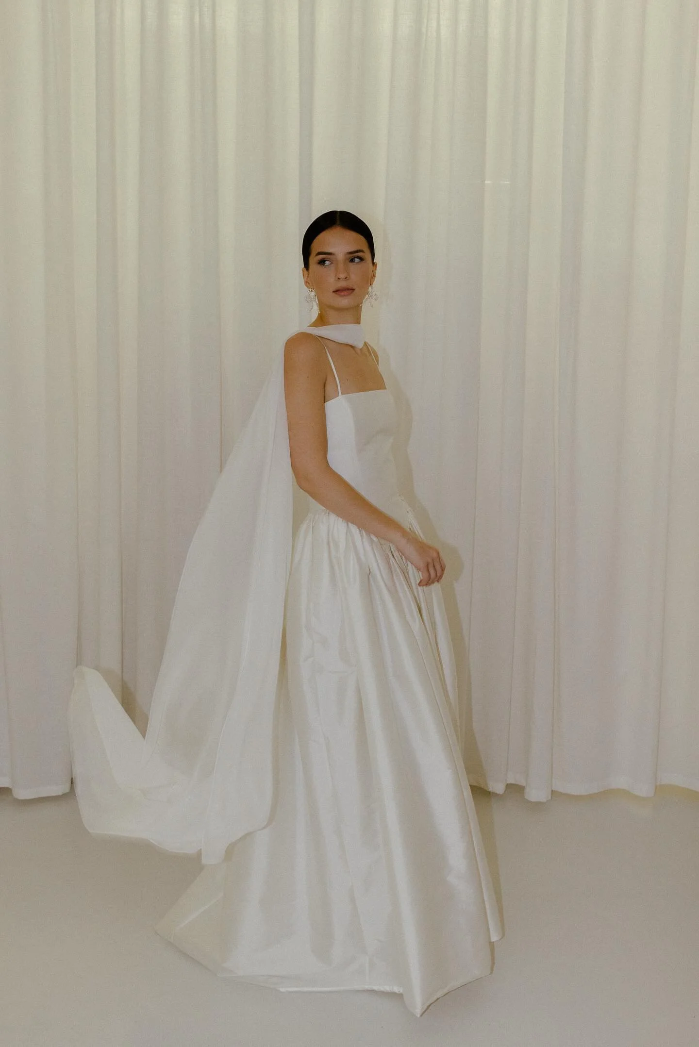 Delphine wedding dress by Jessica Bennett features an extended dropped waist bodice, cut to highlight the feminine form and full
gathered skirt 