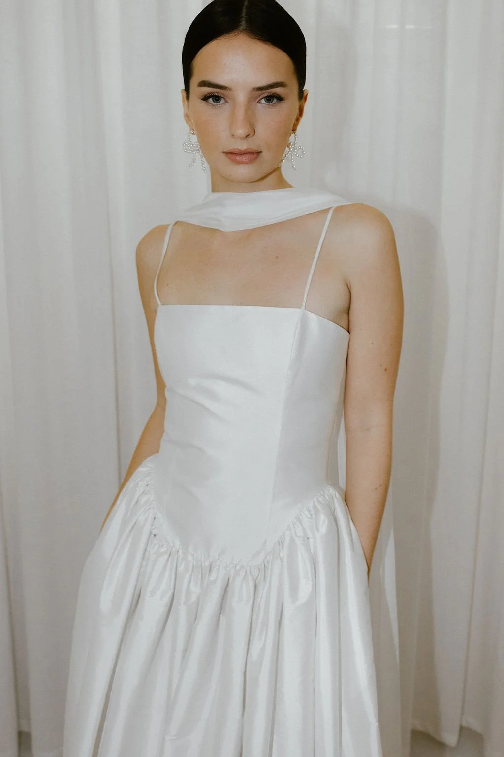 Delphine wedding dress by Jessica Bennett features an extended dropped waist bodice, cut to highlight the feminine form and full
gathered skirt 