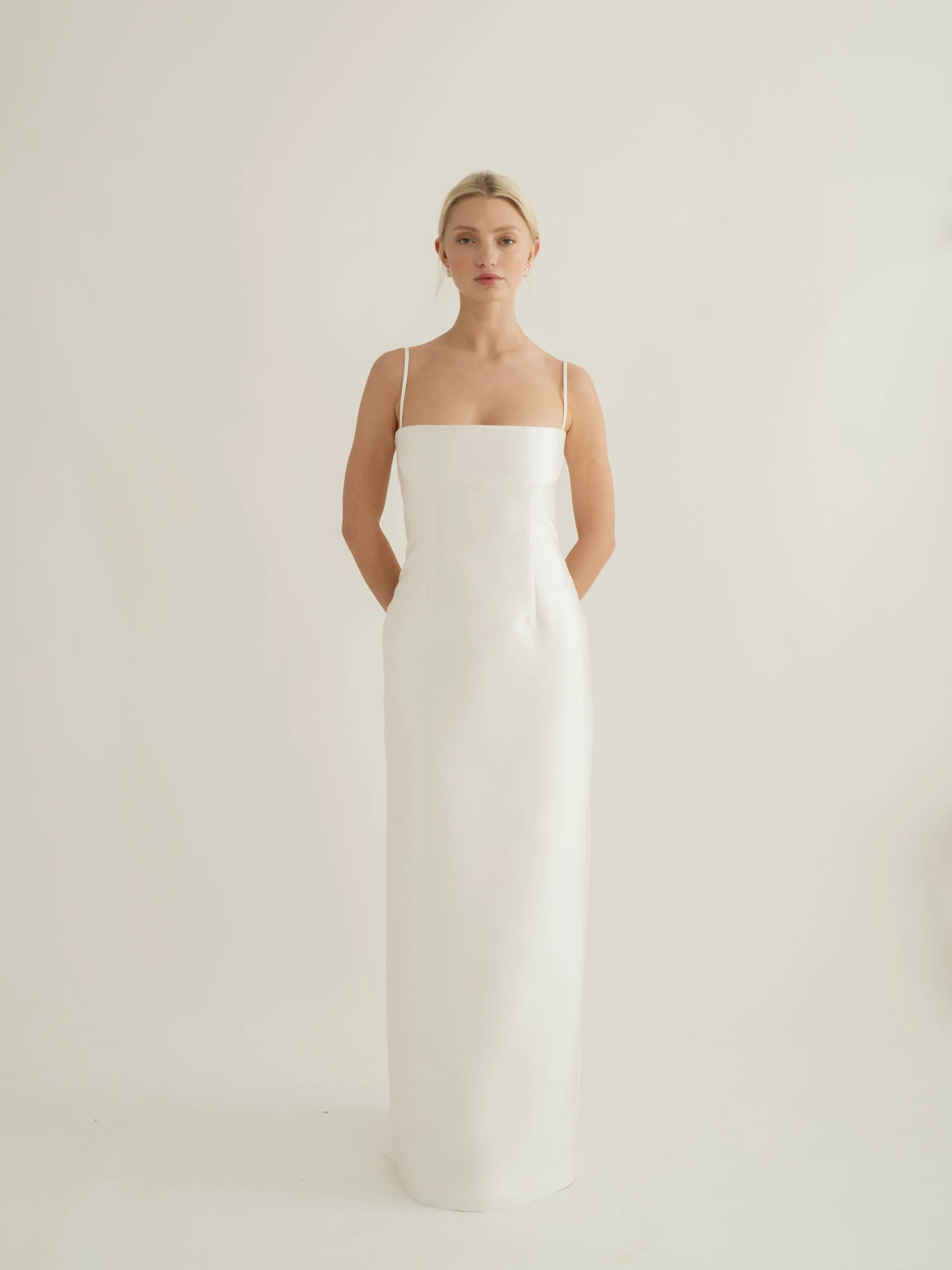 When wedding dress by Jessica Bennett a minimalistic gown which features
a darted waist and column skirt silhouette with removable train 