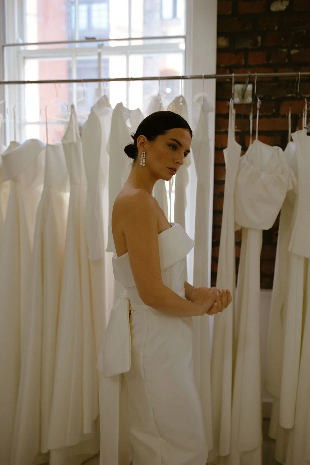 Effortlessly elegant, the Alexa Midi is a modern bridal silhouette crafted in our signature Mikado. A supportive boned internal bodice and refined bias band neckline create a beautifully structured fit, while the sleek column skirt offers clean, unde