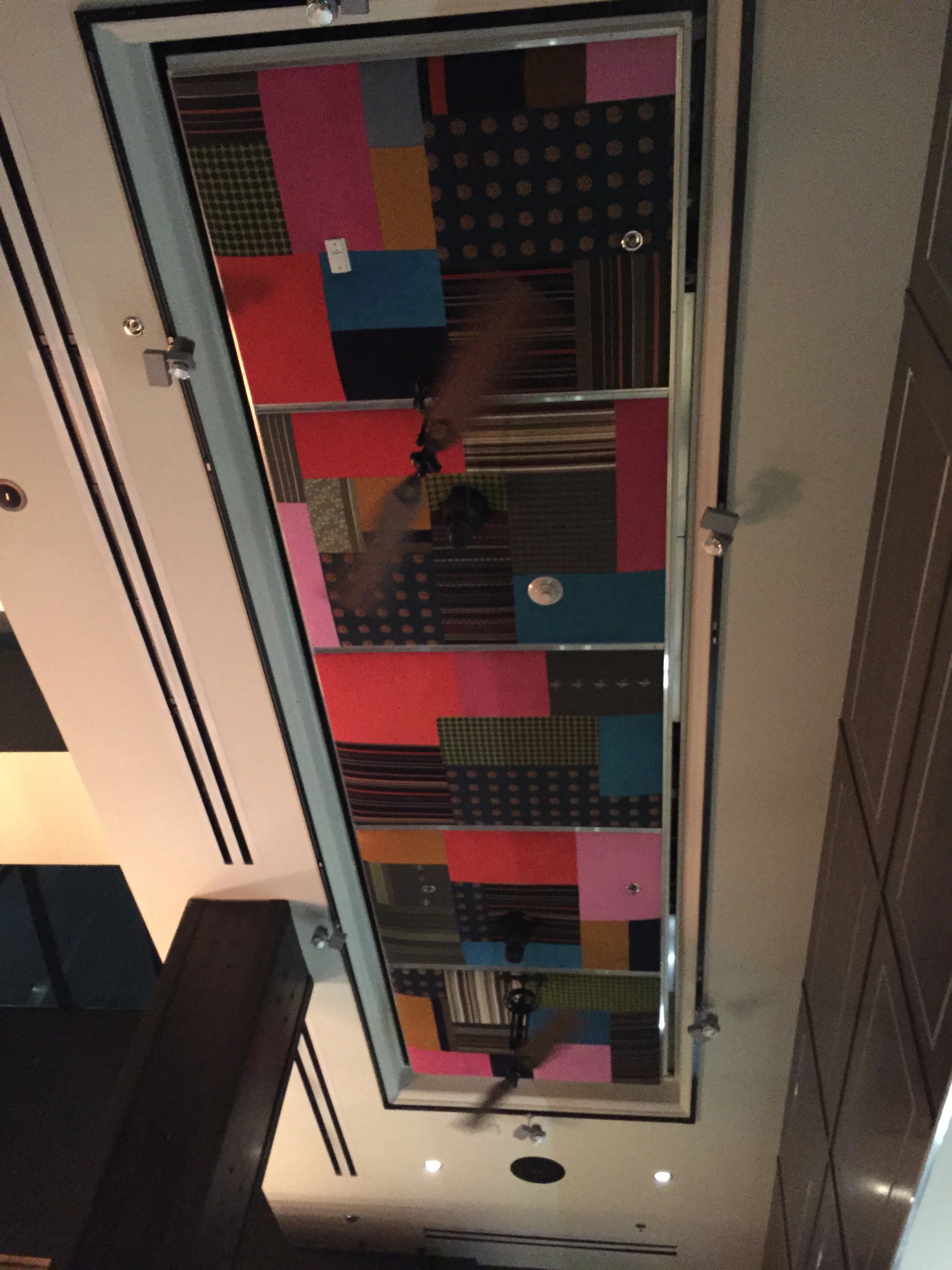 The ceiling is covered in fabric swatches, so awesome.