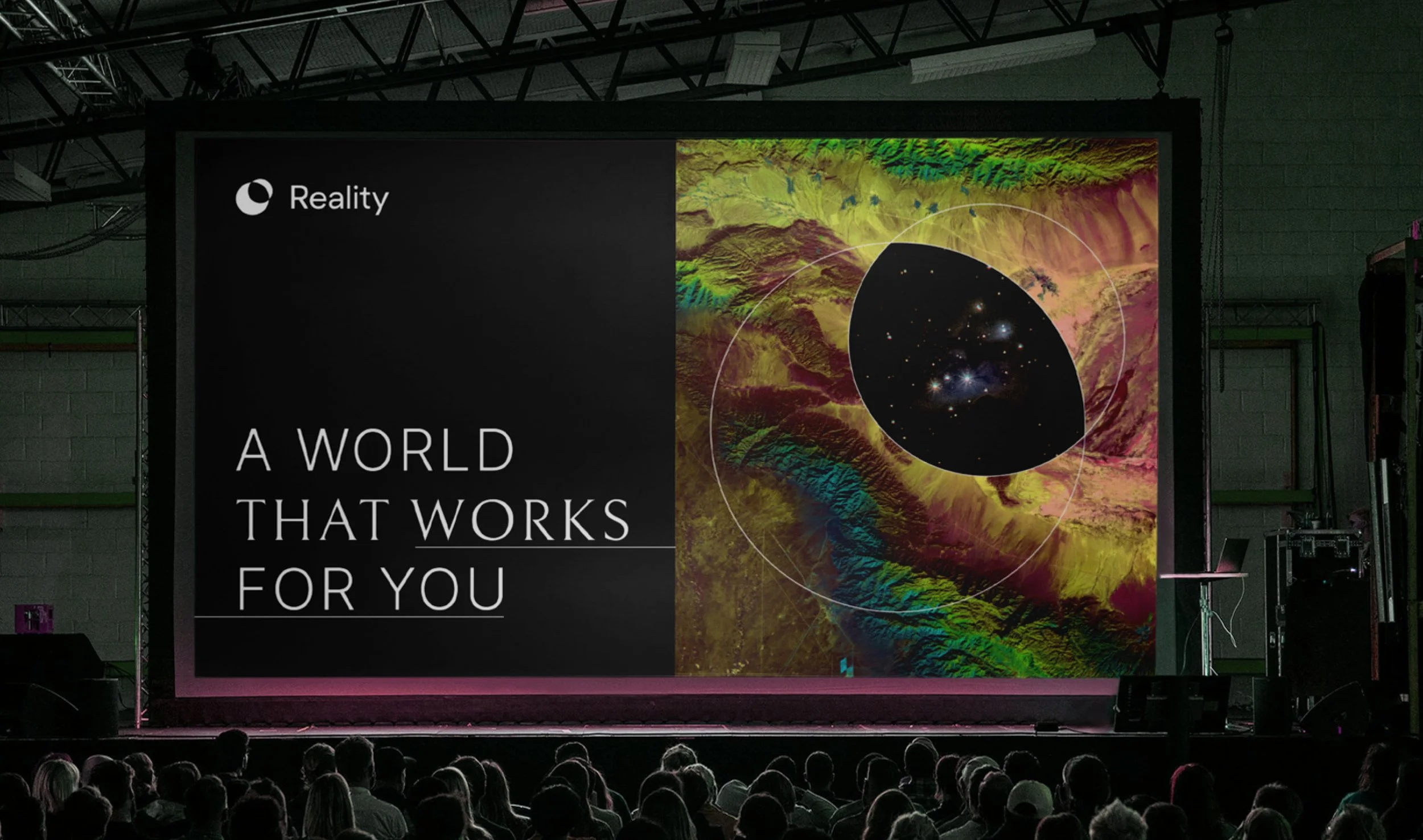 Brand presentation graphic displayed on a large screen in an auditorium setting filled with an audience.