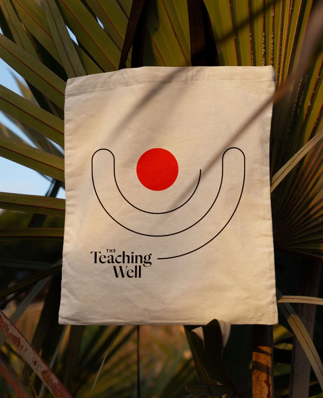 Canvas tote bag promotional merchandise featuring The Teaching Well logo design.