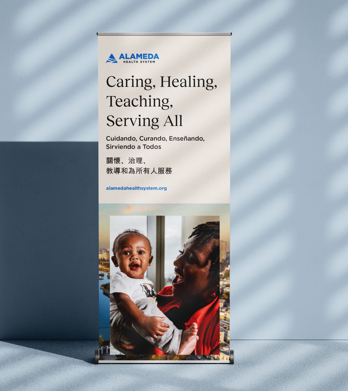A professional printed pull-up display banner featuring multi-language translations for in-hospital patient communication.