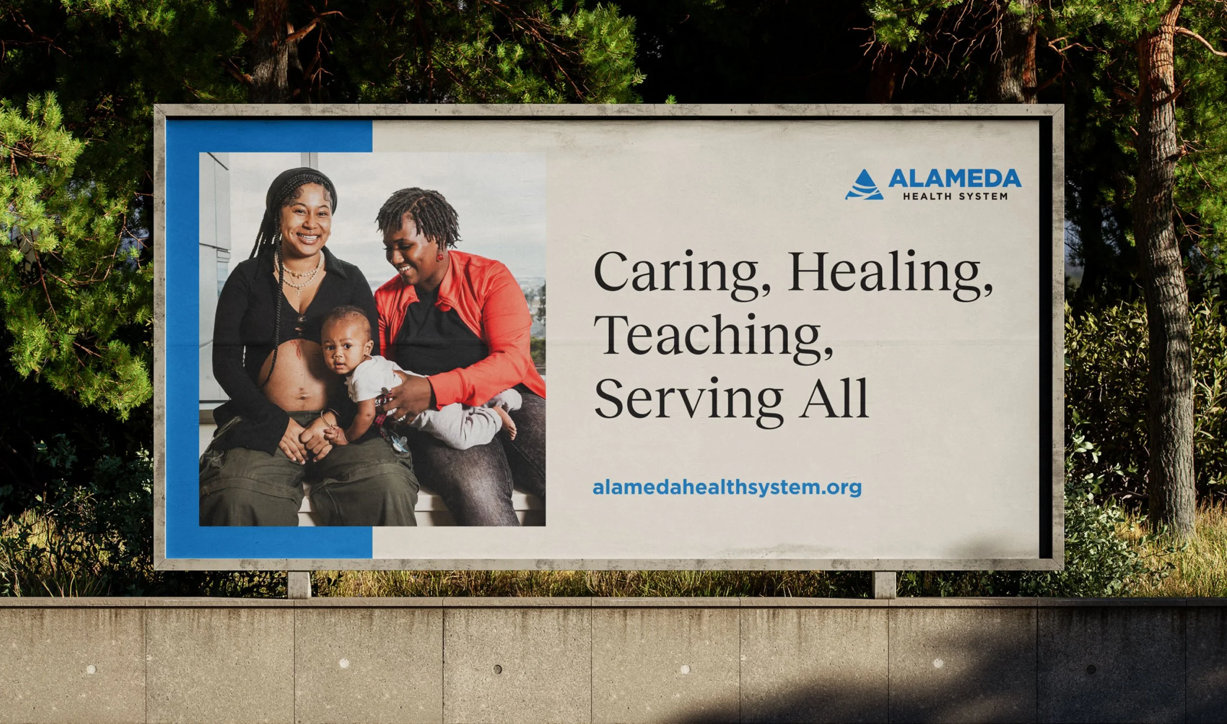 A large outdoor advertising street billboard showcasing a clean healthcare brand marketing campaign for Alameda Health System.